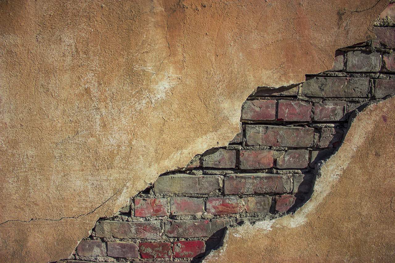 Sealing cracks and holes around a home's exterior to prevent pest entry