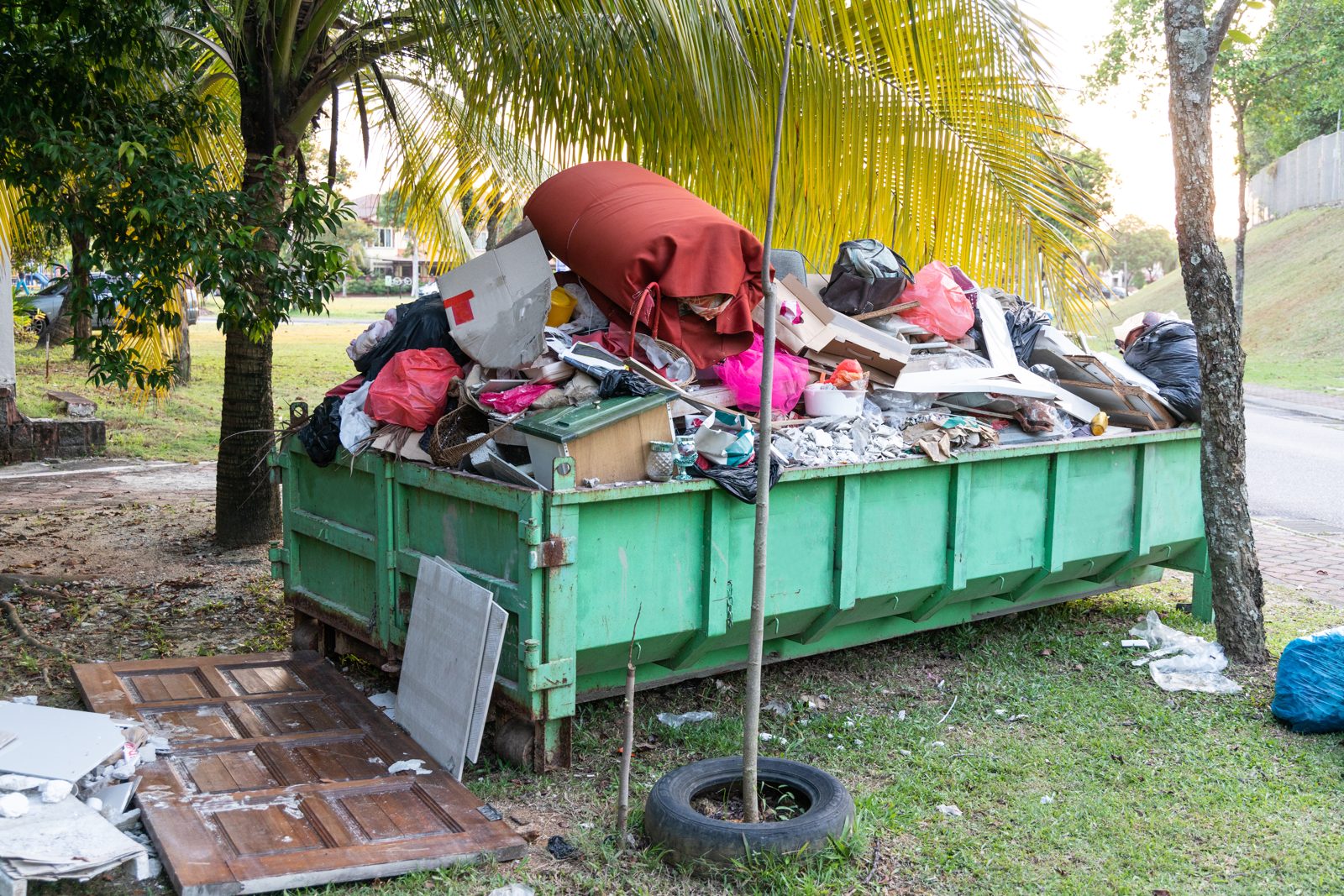 Rubbish dumpster bin overloaded with discarded material